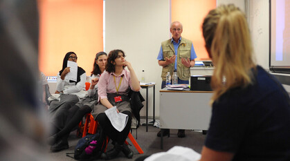 School students listening to a workshop speaker in a school