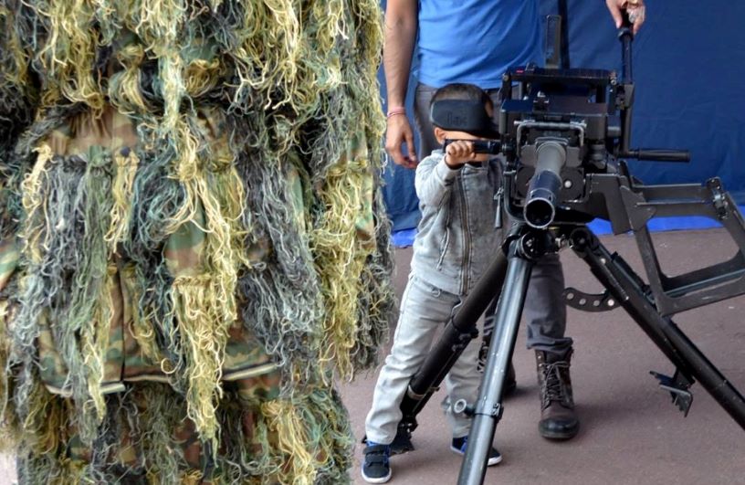 boy behind large gun