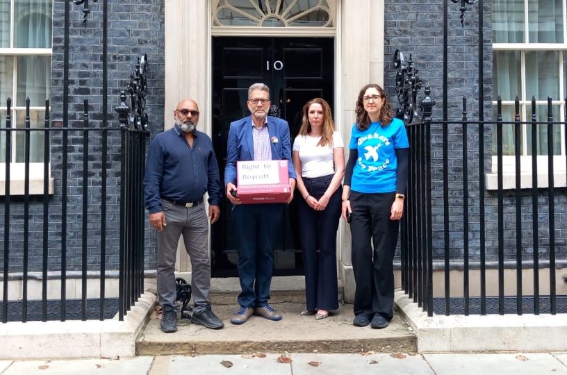 Four people standing in front of no.10 Downing Street