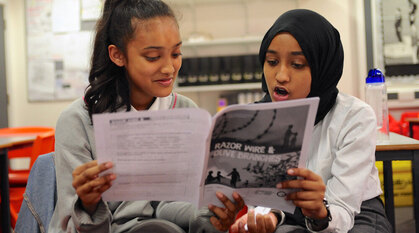 Two students look at study material