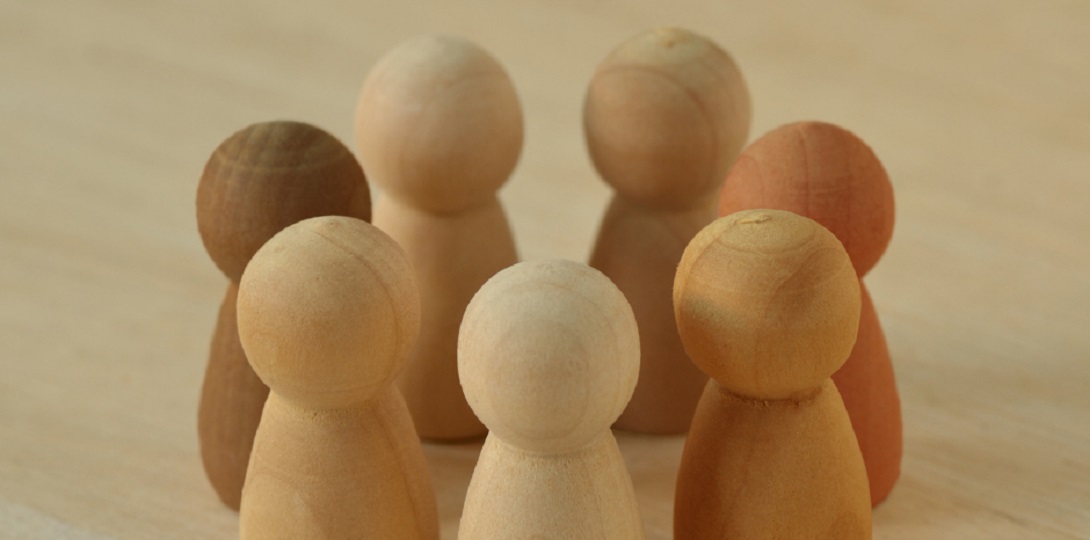 People-shaped game counters in different shades of cream and brown
