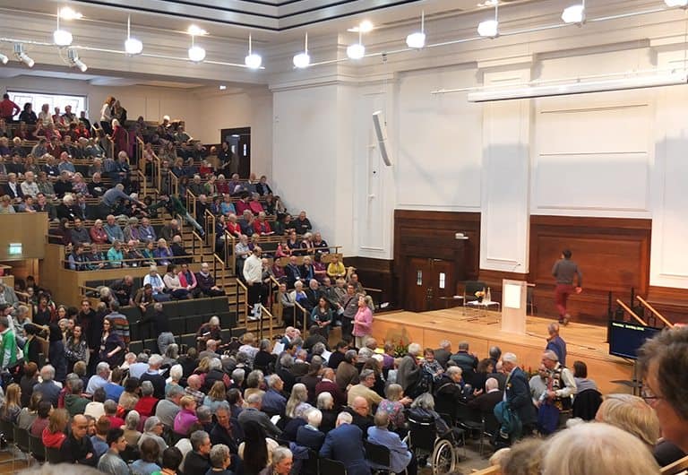 people gathered in a large light hall