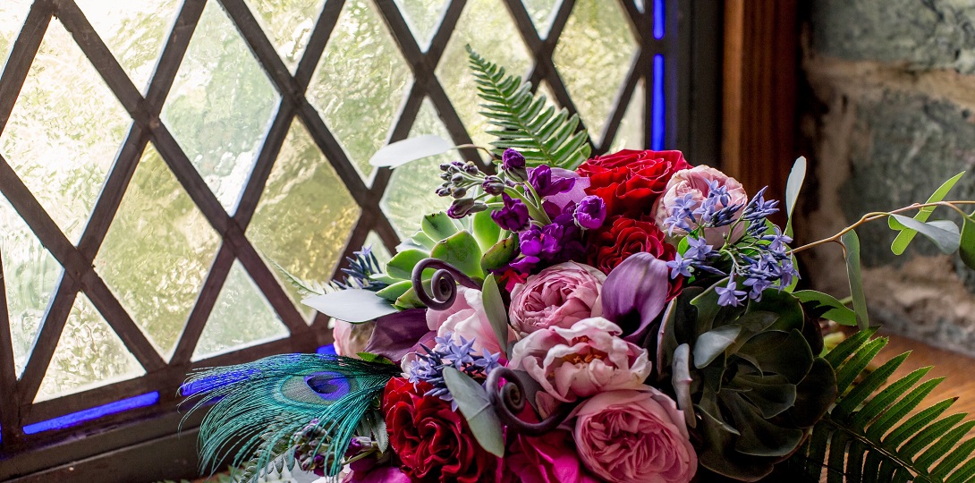 A bouquet of flowers on a window ledge