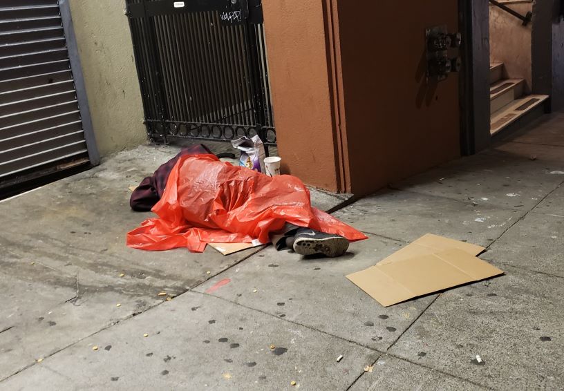 man asleep on street