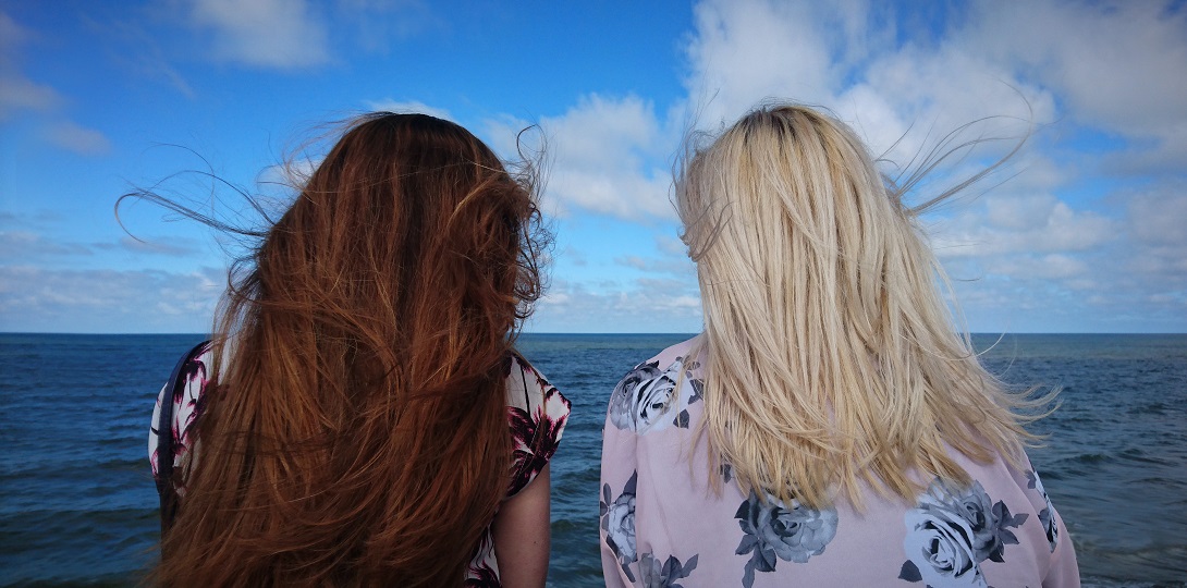 Two women in conversation, seen from behind