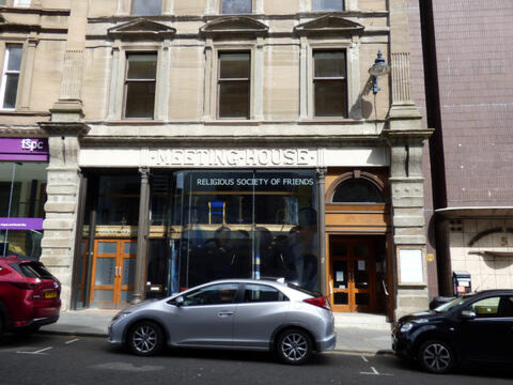 Townhouse facing onto street, 'Meeting House' carved above glass front entrance.