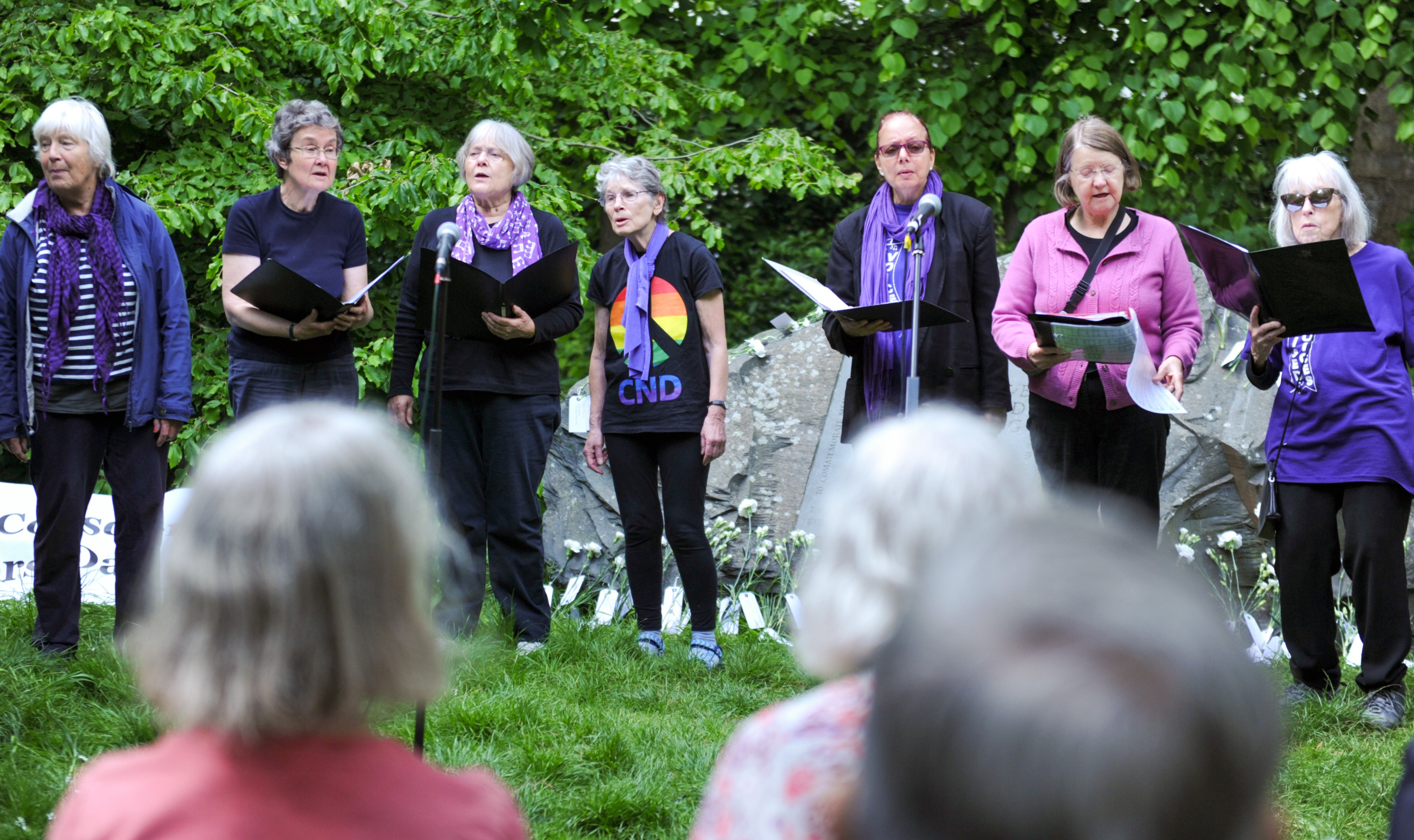 women in purple singing