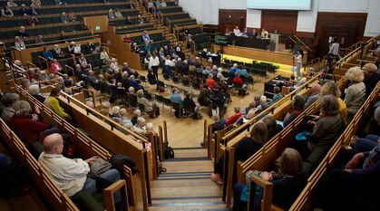 People sat in the Large Meeting House at Friends House during Yearly Meeting 