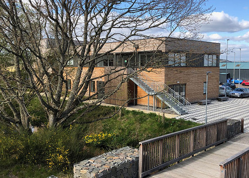 Modern tiber-clad building with flat roof