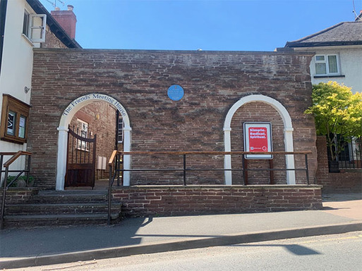 Arched doorways in a stone entrance to meeting house.