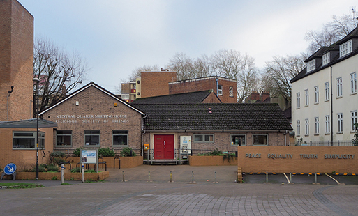 Brick bungalow and car park with large lettering reading 'Central Quaker Meeting House, Religious Society of Friends'.