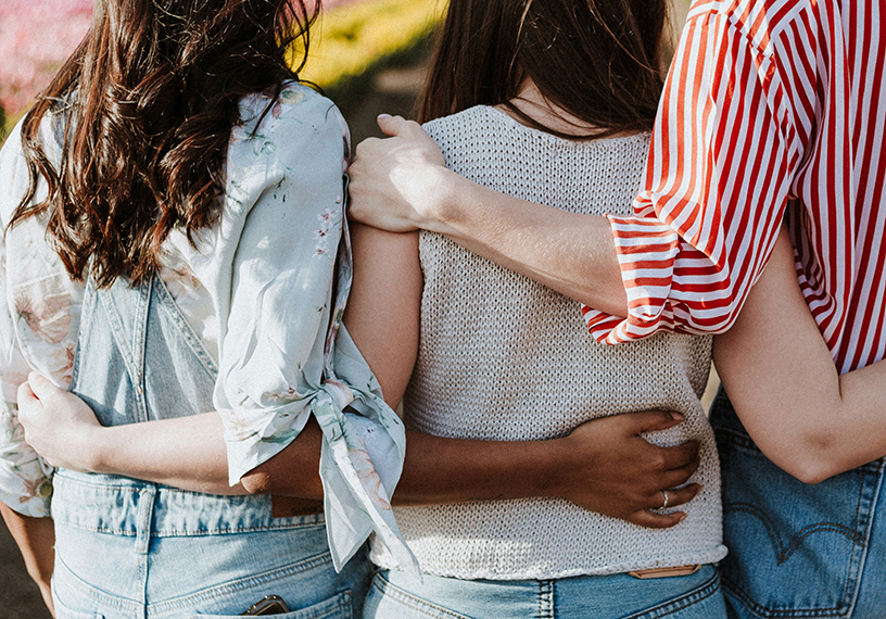 womaen with arms around each other