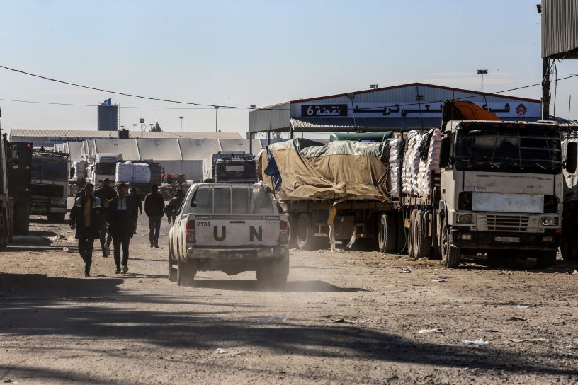 Dusty road and aid trucks