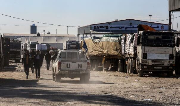 Aid trucks on a dusty road