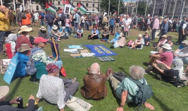 People seated in circle on grass
