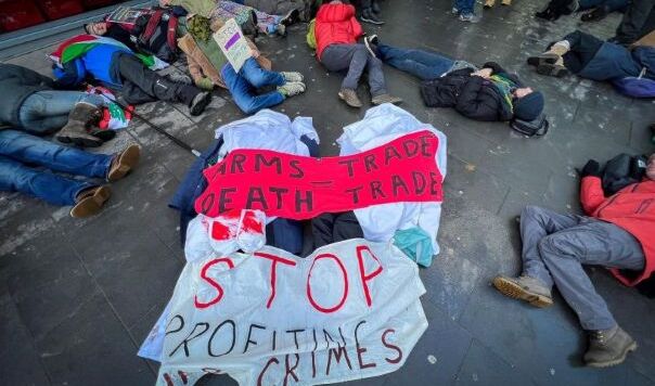 People lying outside under banners