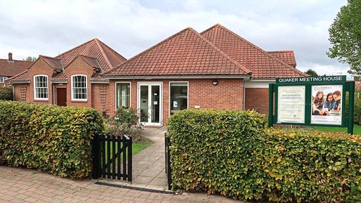 Red brick, single-storey, building with red tiled roof.
