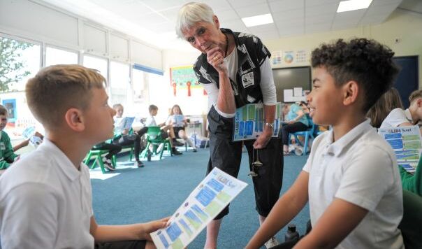 two children and a woman talking to them