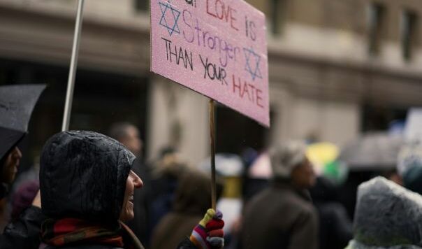 Pink banner reading our love is stronger than your hate