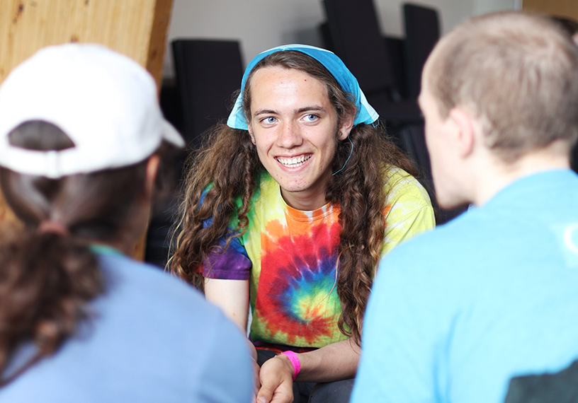 Young person talking to others.