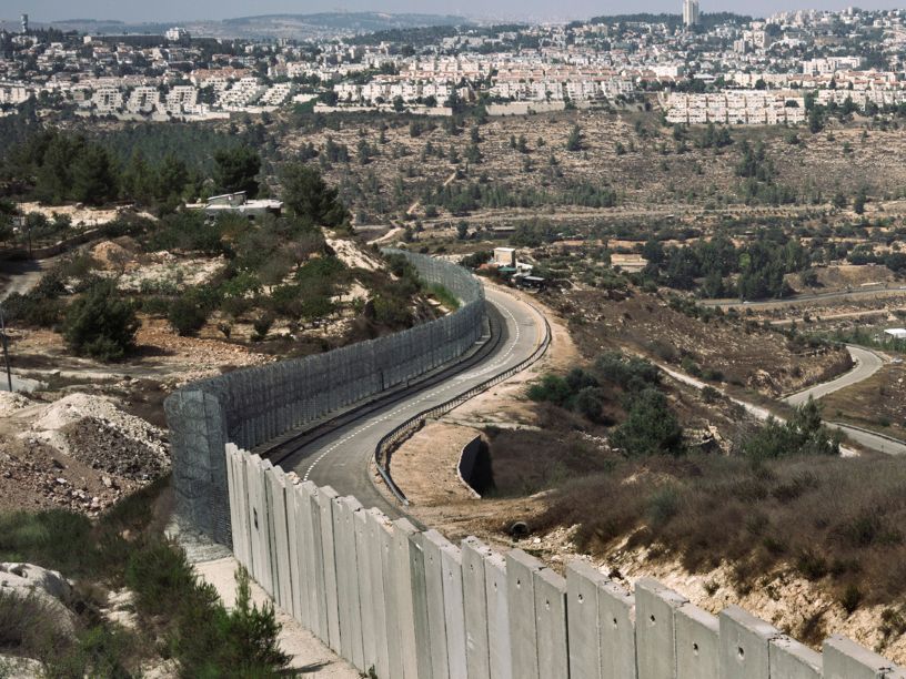 Big concrete wall dividing two areas of land