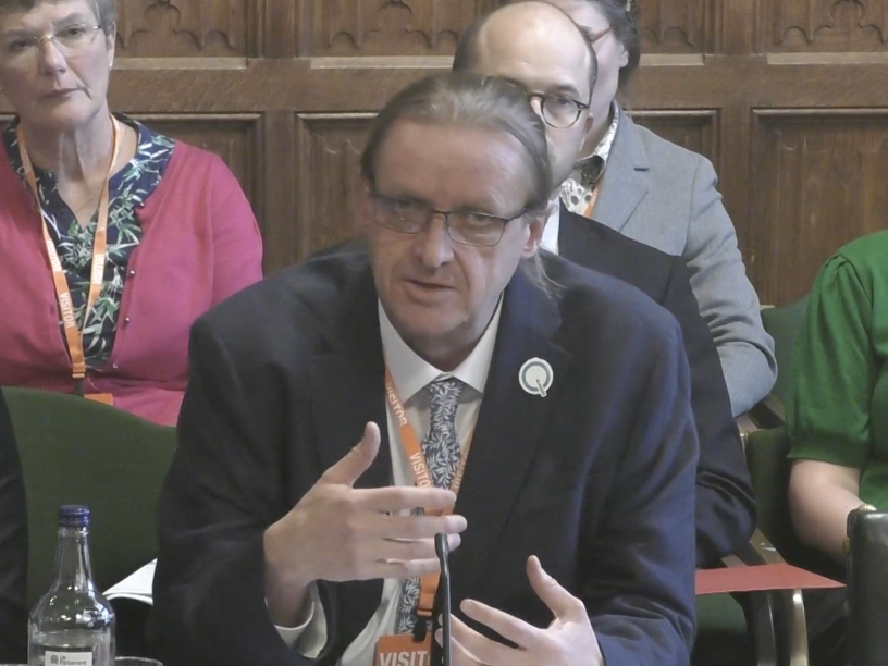 Man in suit and tie gesticulating with hands