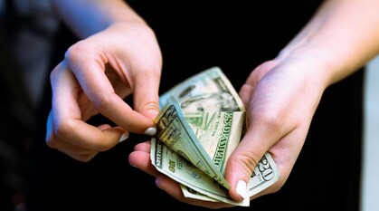Hands holding and counting out currency