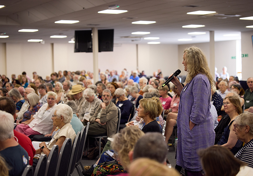 Woman speaking in a large 